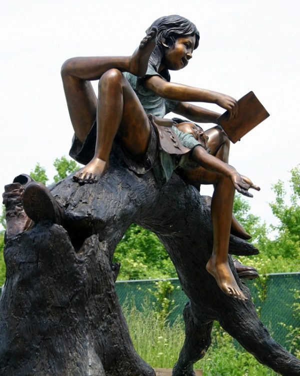 Boy and Girl Reading On A Tree Branch